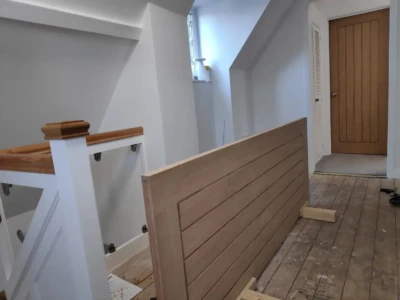 Mal planes down a new oak laminated door and marks out hinges ready for embedding with a palm router